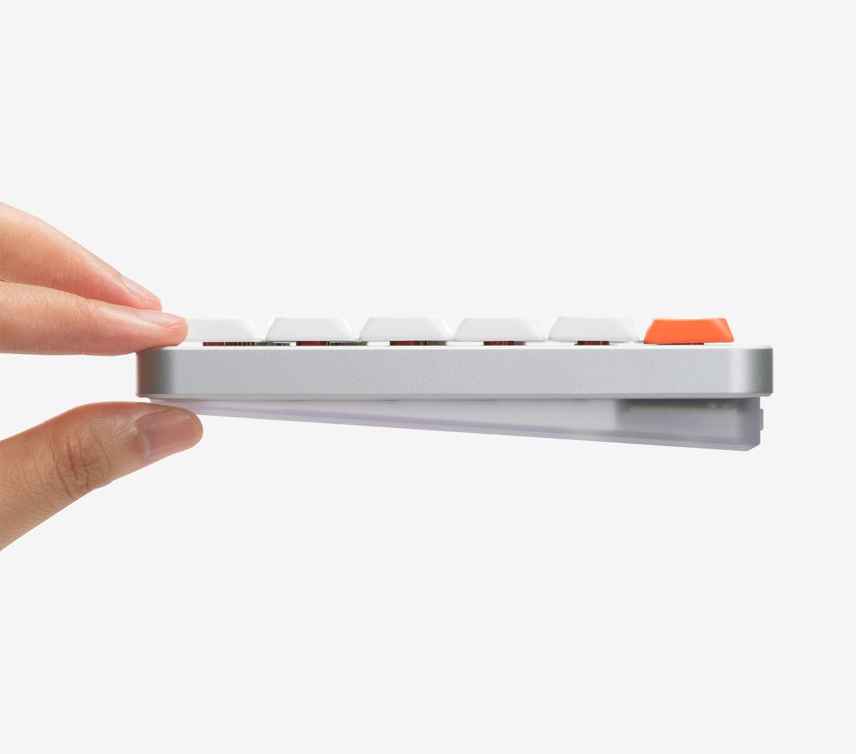 Hand holding the side of the NuPhy Air75 V3 keyboard showing its 13.2mm thin profile