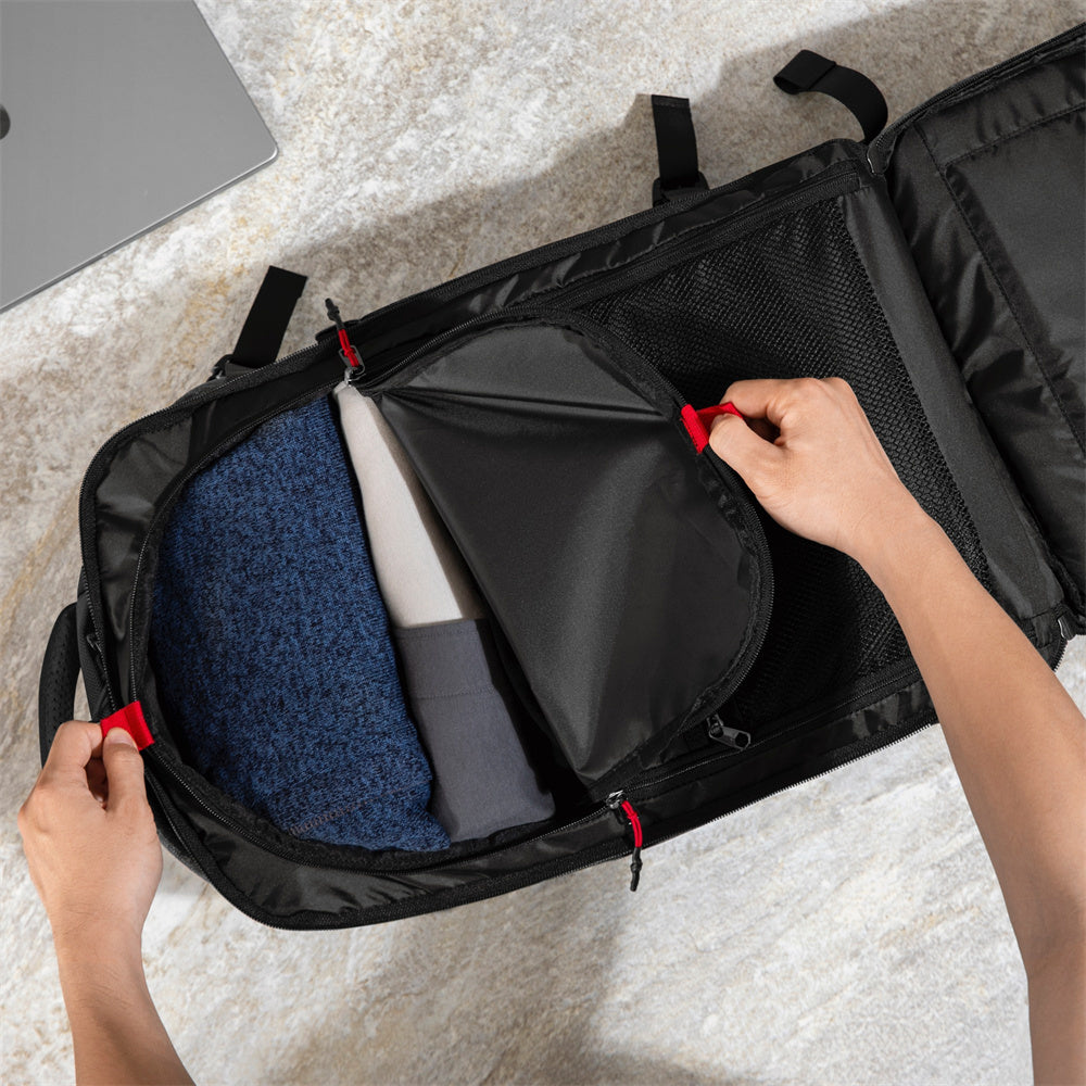 Navigator-T66 backpack opened flat like a suitcase, being packed with clothes and a laptop