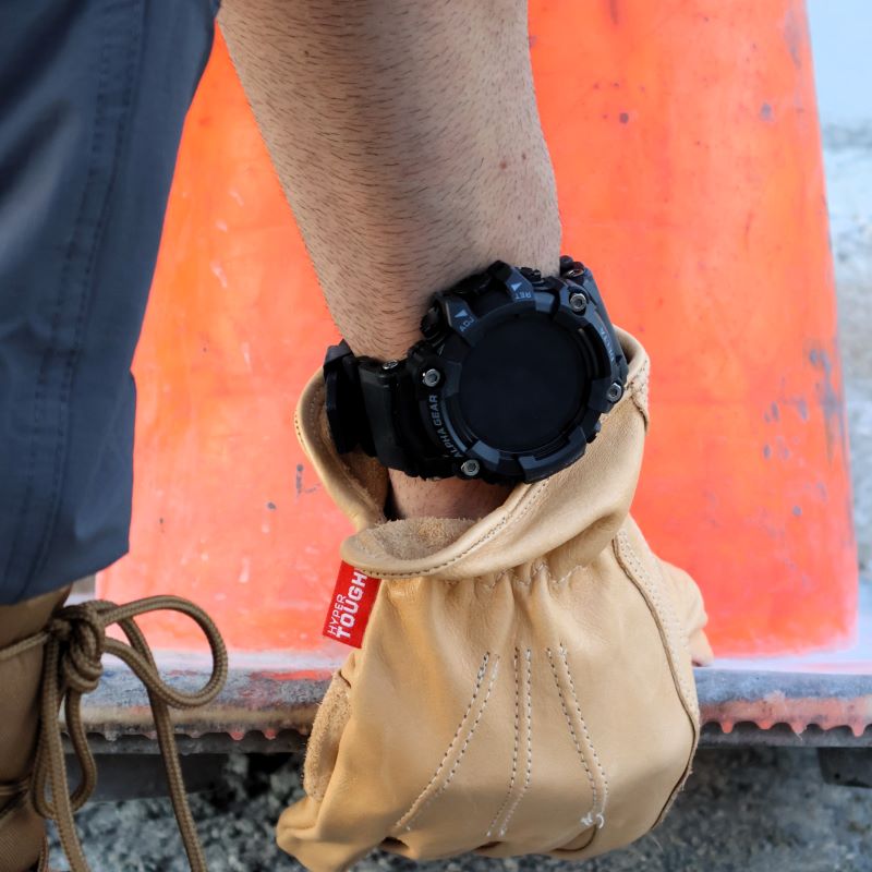 AlphaGear Delta Smartwatch worn on a job site with a work glove