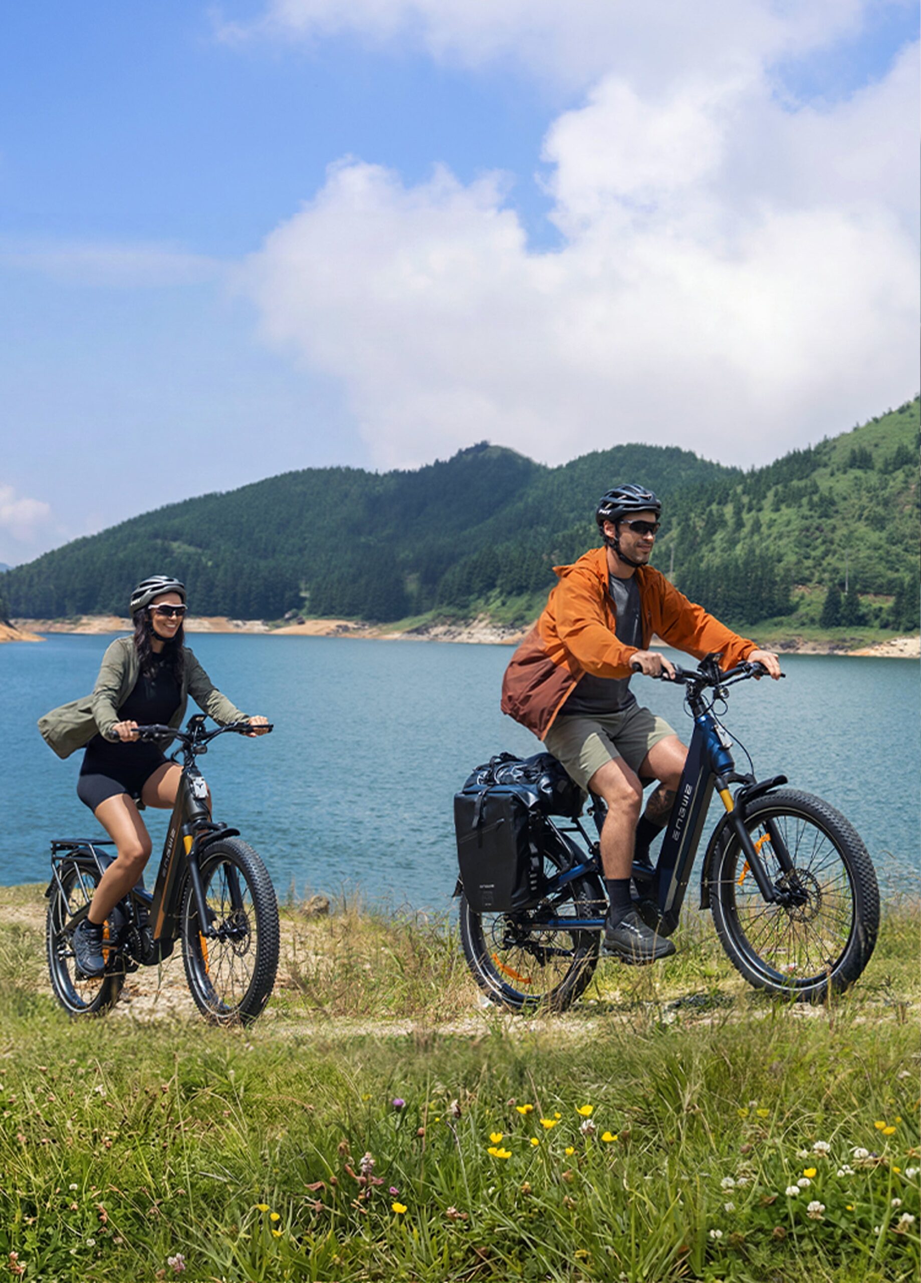 Two riders on ENGWE E26 3.0 Pro electric bikes on a gravel trail beside a lake