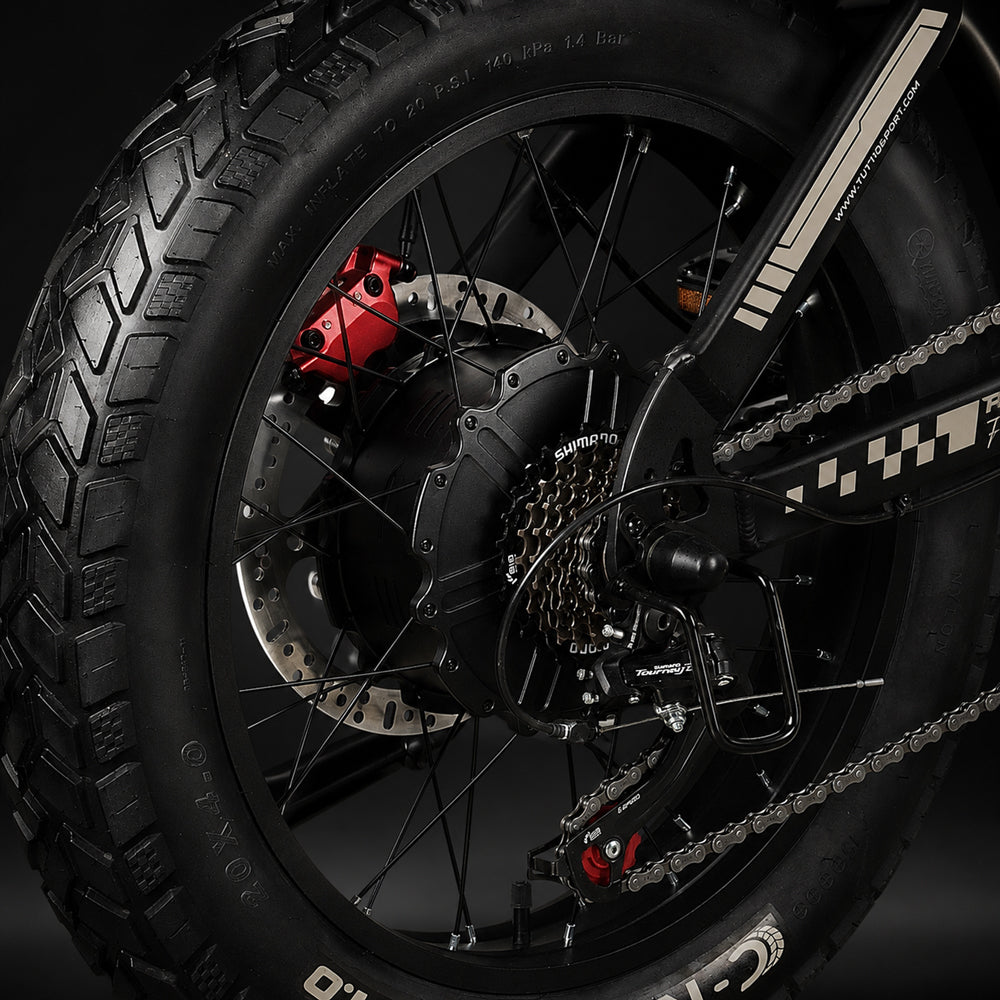 Close-up of the Tuttio ICT 2.0 rear wheel showing the hydraulic disc brake, Shimano derailleur, and fat tire